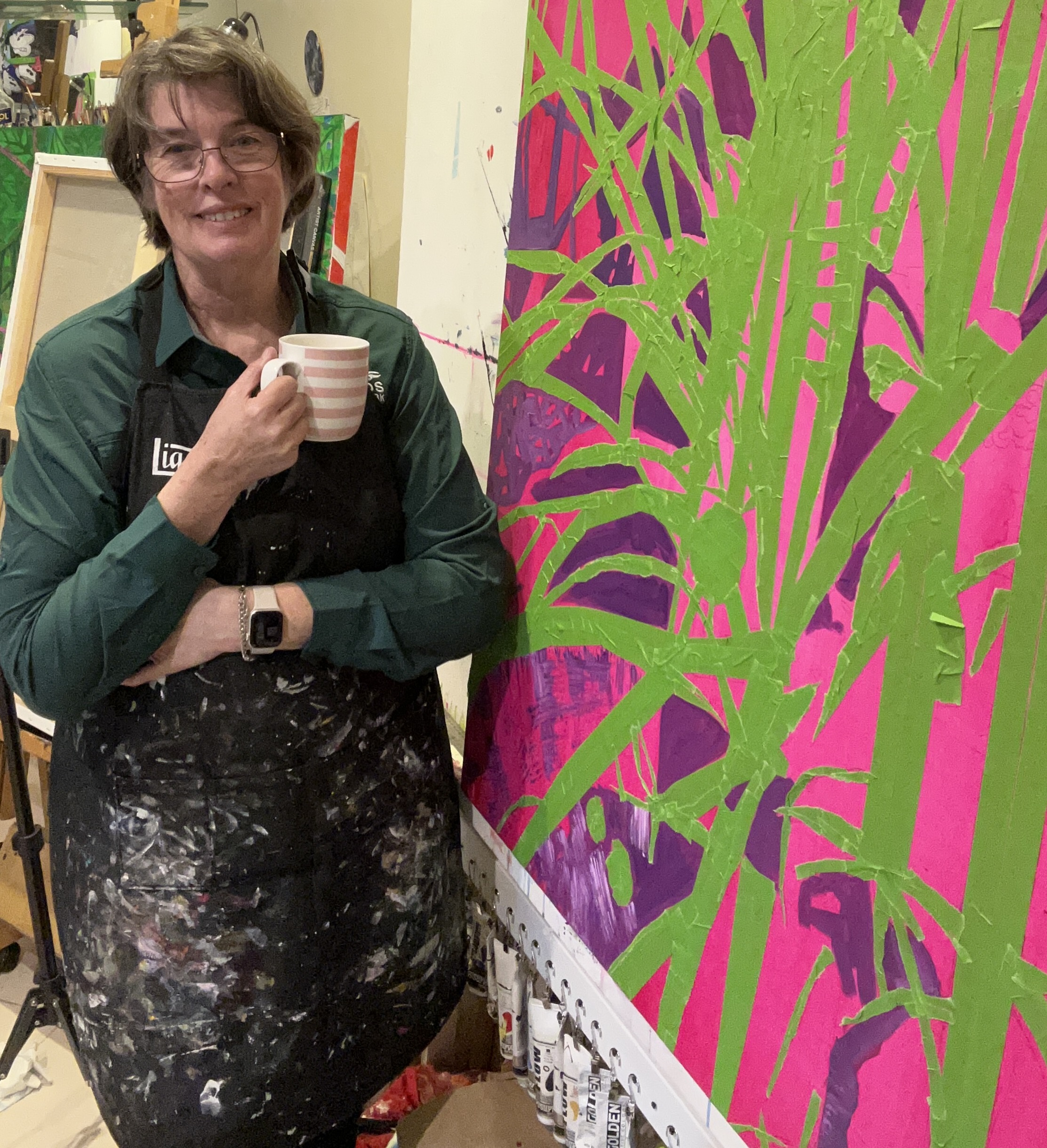 Cathy Schultz painting in her studio